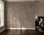 A textured beige and brown distressed industrial wall mural or wallpaper shown in a styled bedroom setting with dark wood floors, a window, and a bed.