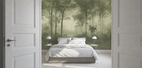 A bedroom interior with a large wallpaper mural showing a misty green forest scene behind a neatly made bed with white bedding. White doors frame the left and right sides of the view.