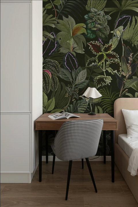 Room interior with a desk, chair, and tropical leaf wallpaper.