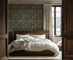 A bedroom with walls covered in a geometric wallpaper featuring Art Deco lines and palm tree motifs, with deep noir background and luminous gold detailing.