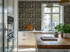 Modern scandinavian kitchen with a kitchen island with basil plants, and a tropical art deco wallpaper. 