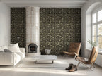 Modern living room with an art deco wallpaper with tropical motifs, brown lounge chairs, and a white sofa. 