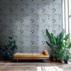 Living room with floral wallpaper, brown leather bench, and potted plants.