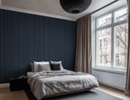 Scandinavian styled bedroom with navy and gold striped wallpaper.  