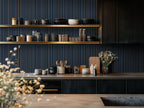 Modern kitchen with striped gold and navy wallpaper. 

