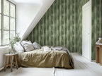 Bedroom with beige sheets and a green striped wallpaper