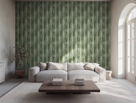 Modern living room with a grey sofa, and painted wallpaper with green stripes. 