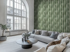 A modern living room with large windows, featuring walls covered in a green, striped wallpaper with a design mimicking the look of a waterfall in a rainforest.