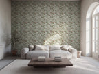 A living room with large windows, featuring a wall covered in floral wallpaper with a geometric trellis design, a white sofa, and a wooden coffee table.