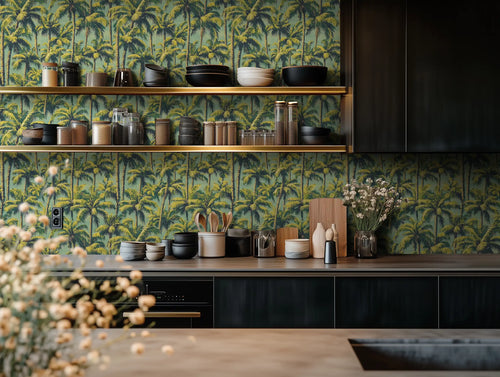 A room with the 'Golden Hour Palms' wallpaper featuring a pattern of lush green palms, with a shelf above the wall displaying various decorative items.