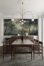 Dining room with a large table, chairs, and a forest wallpaper mural on the wall.