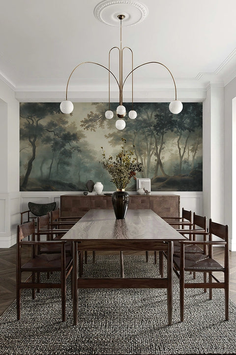 Dining room with a large table, chairs, and a forest wallpaper mural on the wall.