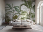 Tropical jungle wallpaper mural with palm leaves, in a modern living room with a grey sofa. 