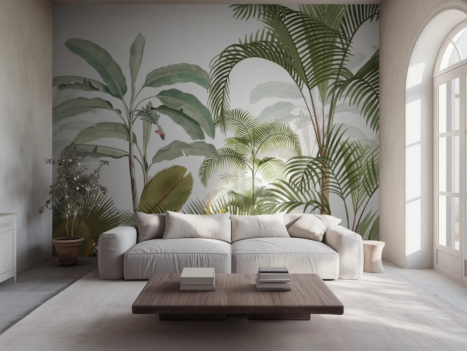 Tropical jungle wallpaper mural with palm leaves, in a modern living room with a grey sofa. 