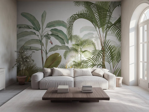 Tropical jungle wallpaper mural with palm leaves, in a modern living room with a grey sofa. 