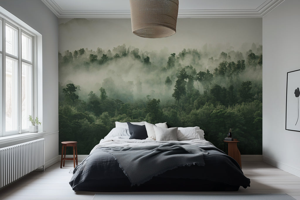 A misty forest wallpaper mural covering a large wall behind a bed in a bedroom setting.
