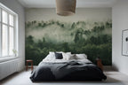 A misty forest wallpaper mural covering a large wall behind a bed in a bedroom setting.