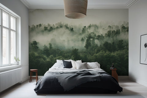 A misty forest wallpaper mural covering a large wall behind a bed in a bedroom setting.