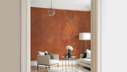 Modern living room with a white arm chair, and a wallpaper mural with industrial rust texture. 