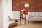 Modern living room with a white sofa, and a wallpaper mural with industrial rust texture. 