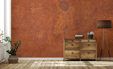 Modern living room with a wooden cabinet, and a wallpaper mural with industrial rust texture. 