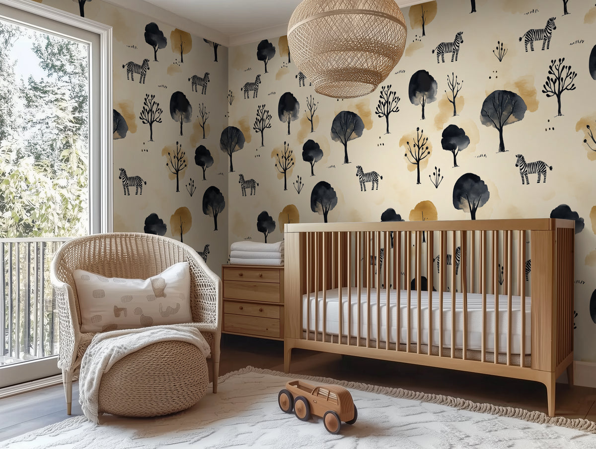 Nursery room with wooden crib, wicker chair, and animal-themed wallpaper.