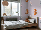 Children's bedroom with a bed, teddy bear, and tiger wallpaper.