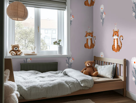 Children's bedroom with a bed, teddy bear, and tiger wallpaper.