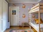 Children's room with a bunk bed, and tiger-themed wallpaper.