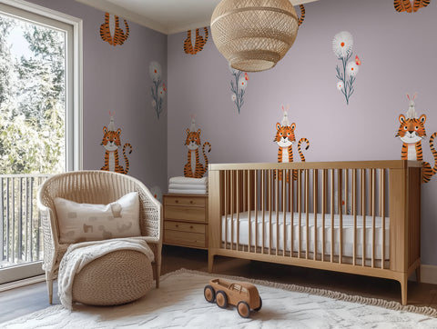 Nursery room with wooden crib, armchair, and tiger-themed wallpaper.