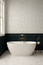 Modern bathroom with a freestanding bathtub, gold faucet, and beige butterfly wallpaper pattern.