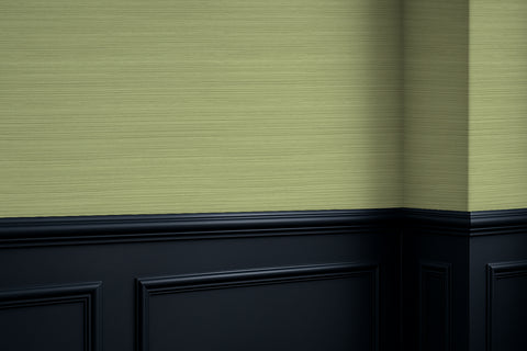 Green textured grasscloth wall with black baseboard