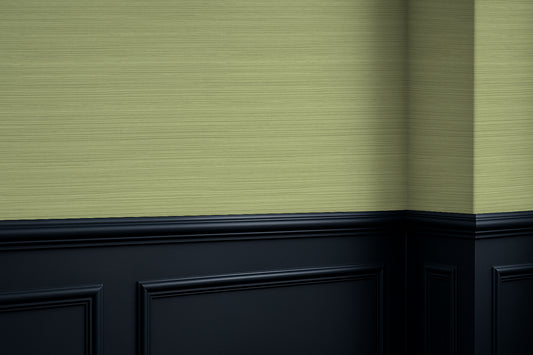 Green textured grasscloth wall with black baseboard