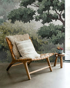 Wooden chair with cushions against a forest-themed wallpaper