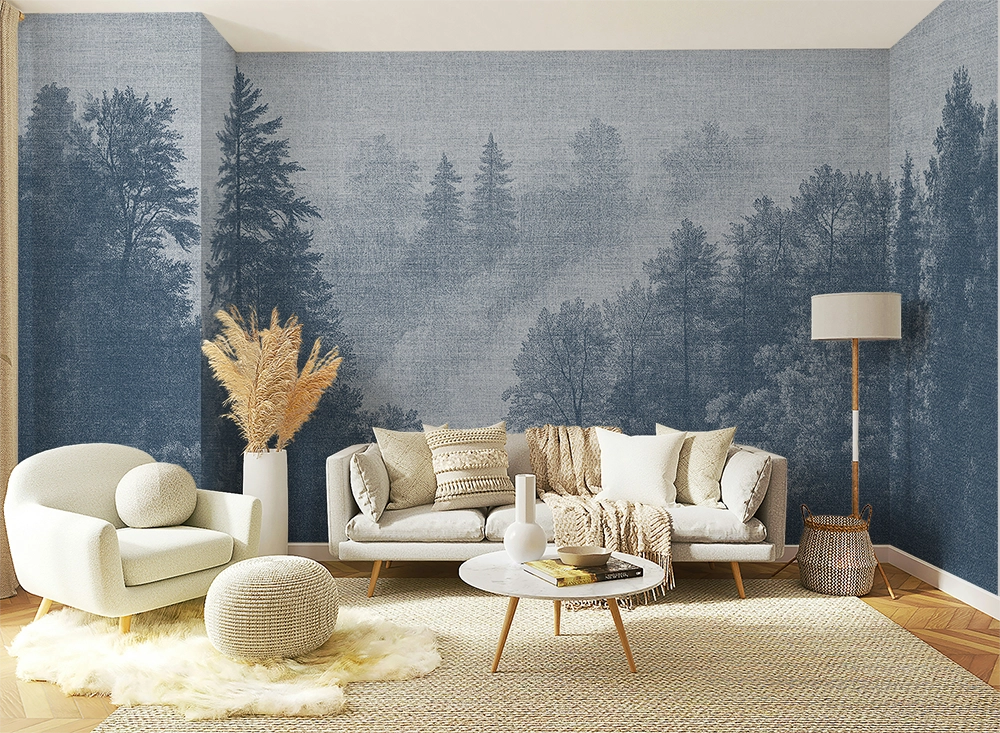Blue forest wallpaper mural in a cozy Scandinavian living room with soft neutral furniture, textured decor, and misty Nordic trees inspired by fjord landscapes.
