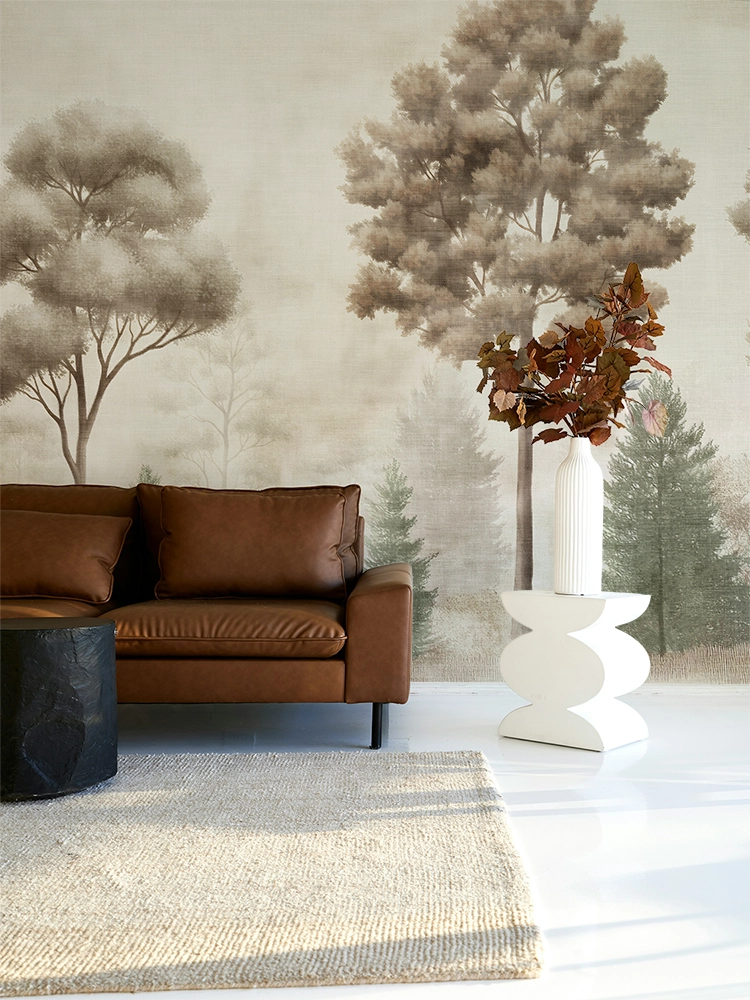 Modern living room with a leather sofa and vintage forest mural wallpaper
