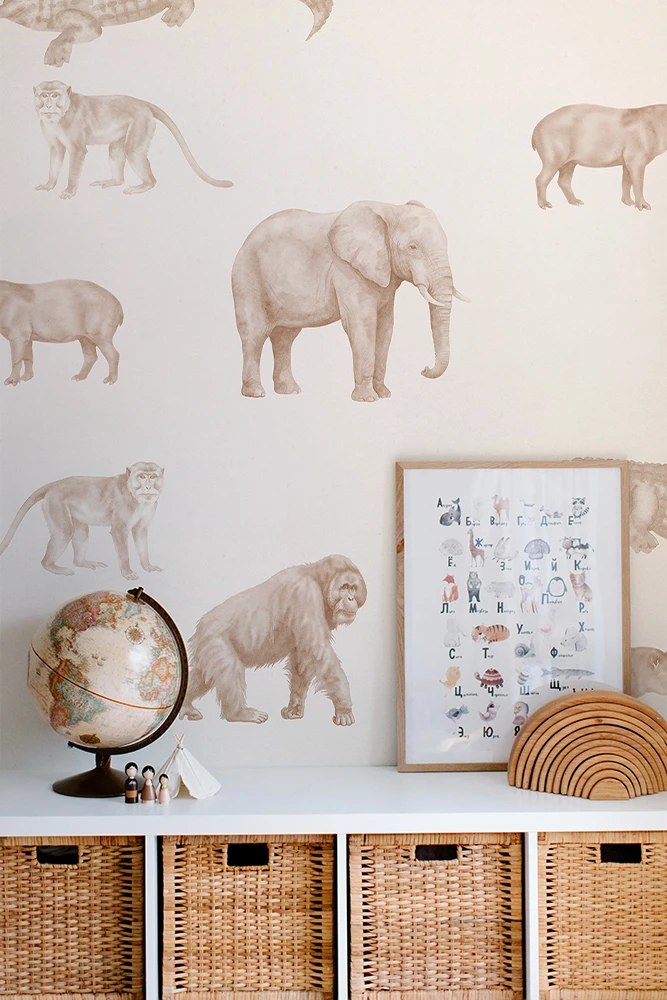 Wall with animal wallpaper, shelf with decor items, and framed artwork.