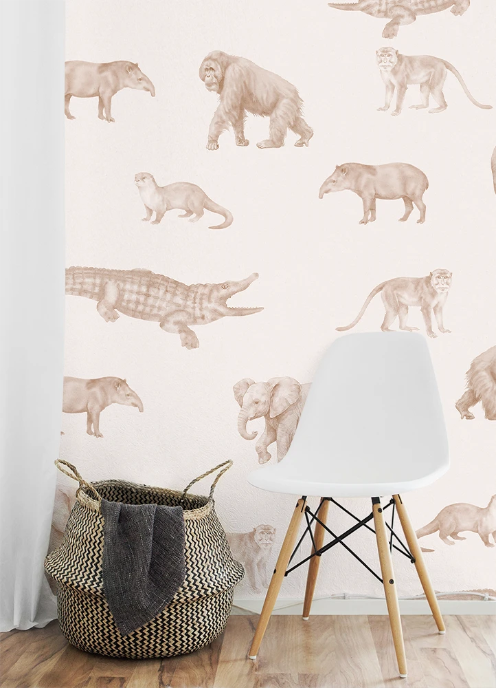 White chair and woven basket against a wall with kids animal wallpaper