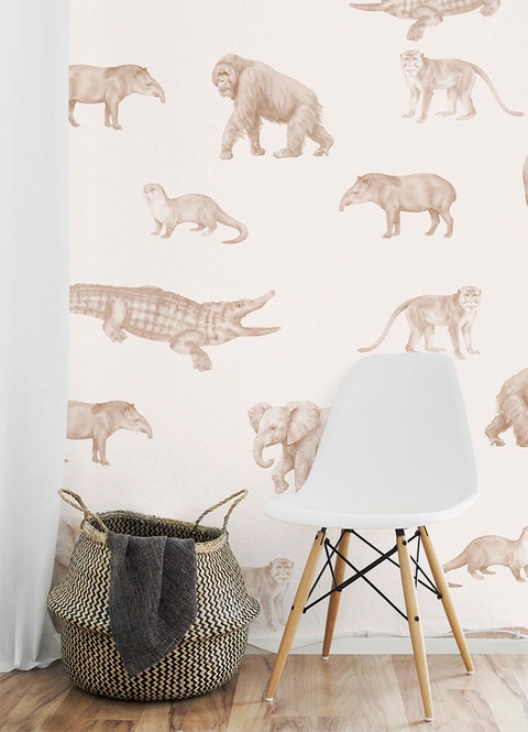 White chair and woven basket against a wall with kids animal wallpaper