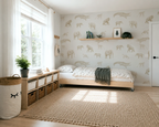 Children's bedroom with animal patterned wallpaper, bed, and storage units.