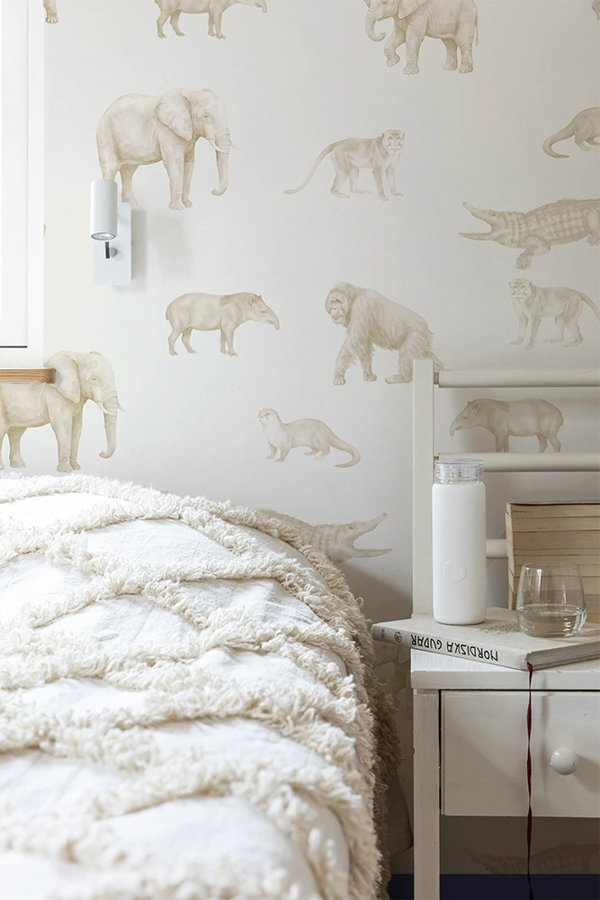 Teenage bedroom with animal-themed wallpaper featuring elephants and crocodiles.