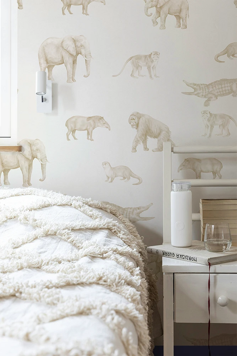 Teenage bedroom with animal-themed wallpaper featuring elephants and crocodiles.