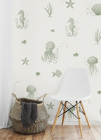 Wall with underwater-themed kids wallpaper, including seahorses, octopuses, and jellyfish, with a white chair and woven basket in the foreground.