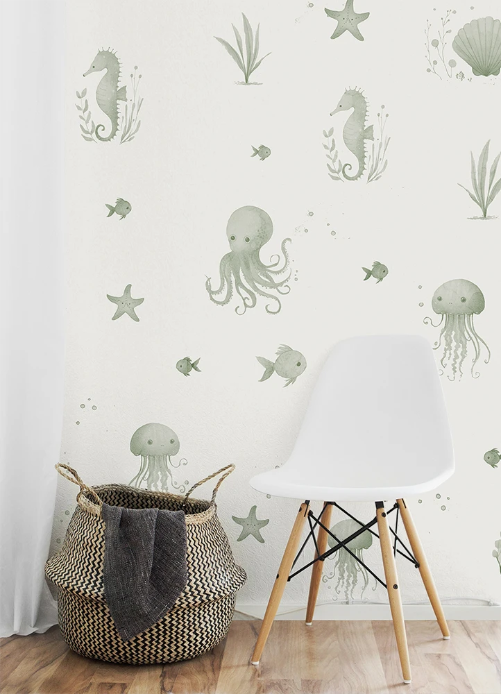 Wall with underwater-themed kids wallpaper, including seahorses, octopuses, and jellyfish, with a white chair and woven basket in the foreground.