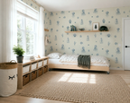 Children's bedroom with wallpaper featuring sea-themed designs, a bed, and storage units.