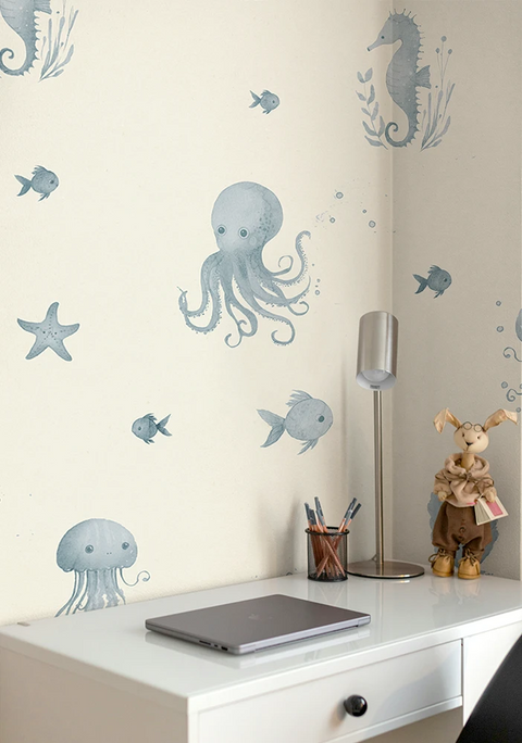Wall with underwater-themed wallpaper including octopus, fish, and seahorse on a light-colored wall.