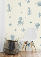 Wallpaper with marine-themed designs featuring seahorses, octopuses, and jellyfish in a room with a chair and basket.