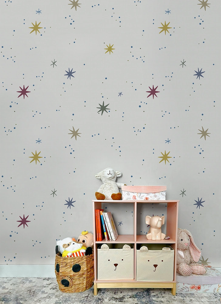 Children's room with a bookshelf, toys, and star-patterned wallpaper.
