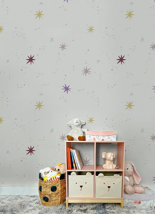 Children's room with a bookshelf, toys, and kids galaxy wallpaper
