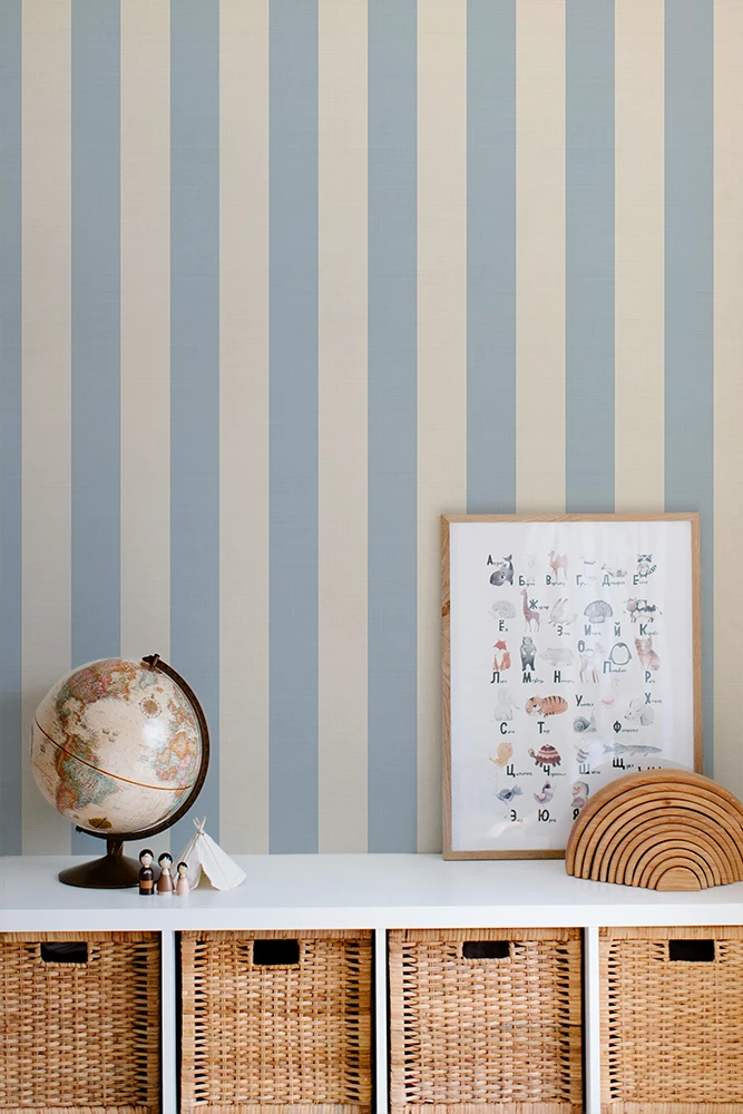 Striped wallpaper with a shelf featuring a globe, framed picture, and woven basket.